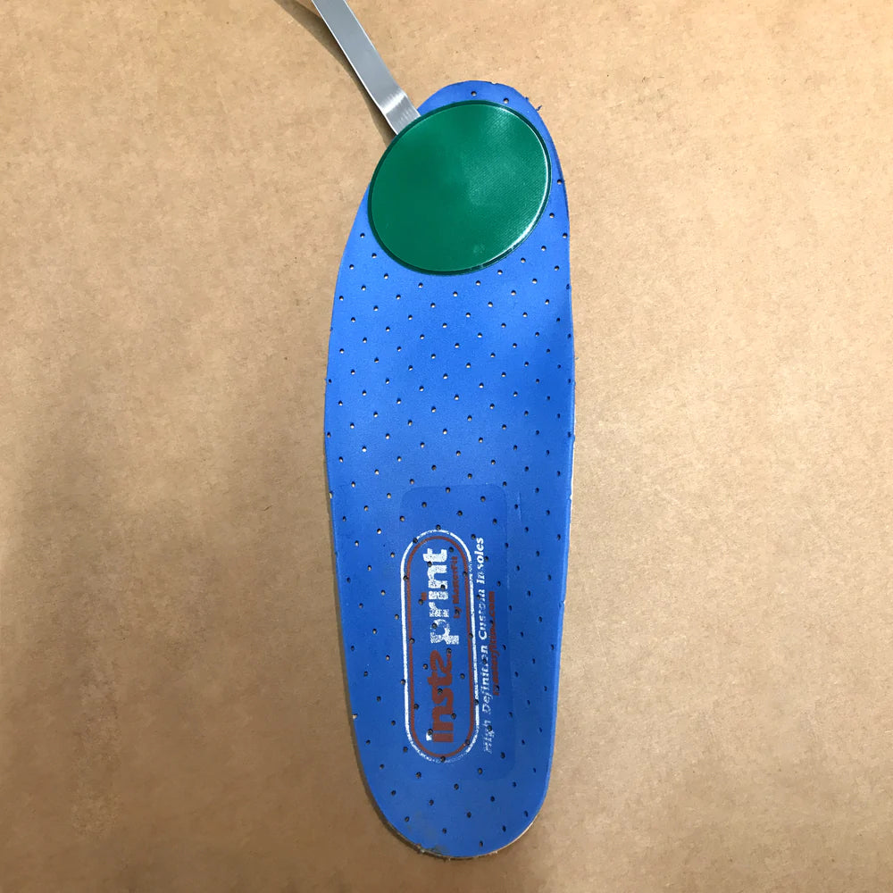 shoe insole with heating pad applied around ball of foot and toes